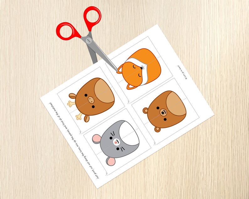 May include: A printable sheet with four animal faces, a fox, a deer, a bear, and a mouse. The sheet is cut out along the lines, ready to be assembled into a matching game.