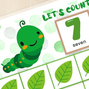 May include: A green caterpillar with a smiling face is on a white background with green polka dots. There are seven green leaves on the page. A brown card with the number 7 and the word "seven" is in the upper right corner. The text "Let's Count!" is in the upper right corner.