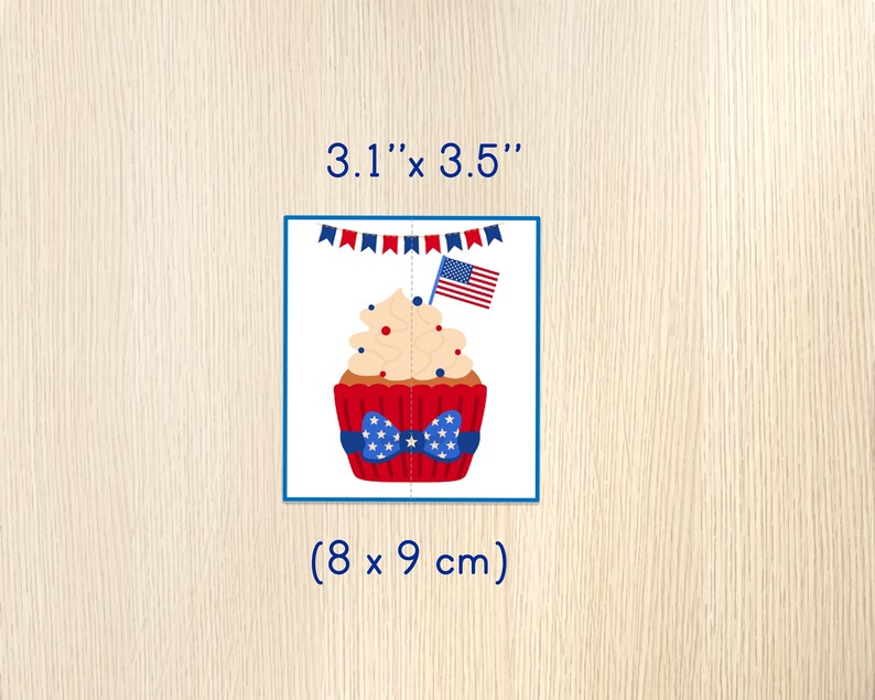 May include: A red, white, and blue cupcake with a white frosting and red and blue sprinkles. The cupcake has a red bow with white stars and a small American flag on top. The cupcake is surrounded by a string of red, white, and blue bunting. The image is 3.1" x 3.5" (8 x 9 cm).