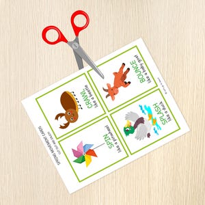 May include: A sheet of spring movement cards with illustrations and text, including a beetle, goat, duck, and pinwheel. Red scissors are cutting the cards. The text says "Cut out and enjoy!"