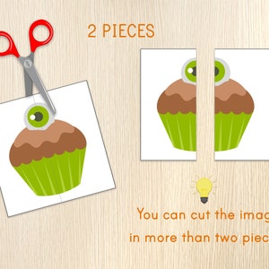 May include: A white card with a cartoon cupcake design, cut in two pieces, with a pair of red-handled scissors. The cupcake has a brown top, green base, and a single eyeball on top. Text reads "2 PIECES" and "You can cut the image in more than two pieces."