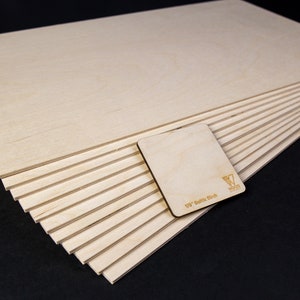 20 pieces of Baltic Birch plywood in a black background.