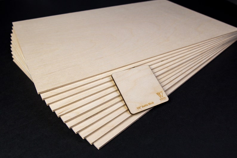 20 pieces of Baltic Birch plywood in a black background.