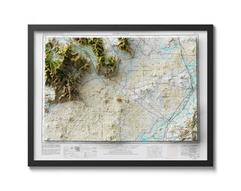 May include: A framed topographic map of the Idaho Falls area, showing elevation changes in shades of green, brown, and white. The map includes roads, rivers, and other geographical features. The title "Idaho Falls" is printed at the top of the map.