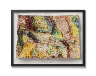 May include: A framed geological map of Wyoming, showing the state's diverse rock formations in a colorful, textured relief style. The map is titled "GEOLOGIC MAP OF WYOMING" and includes a credit to the U.S. Geological Survey.