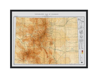 May include: A vintage topographic map of Colorado from 1953. The map shows the state's terrain with brown and red contour lines, roads, and rivers. The map is framed in black.