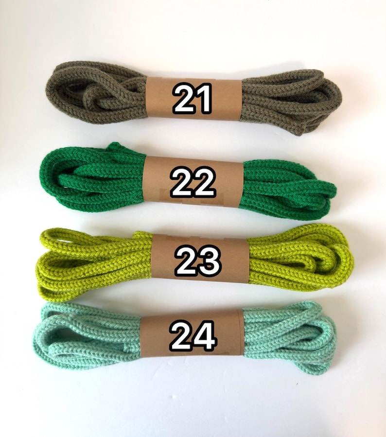 May include: Four bundles of colorful rope, each wrapped with a brown paper band and labeled with a number. The colors include olive green (21), bright green (22), lime green (23), and seafoam green (24).
