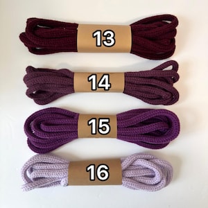 May include: Four bundles of rope in varying shades of purple and burgundy, each wrapped with a brown paper band. The numbers 13, 14, 15, and 16 are printed on the bands. The colors range from deep burgundy to light lavender.