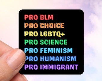 May include: A black square sticker with rainbow text that reads "PRO BLM, PRO CHOICE, PRO LGBTQ+, PRO SCIENCE, PRO FEMINISM, PRO HUMANISM, PRO IMMIGRANT." The sticker is held against a cloudy sky background.