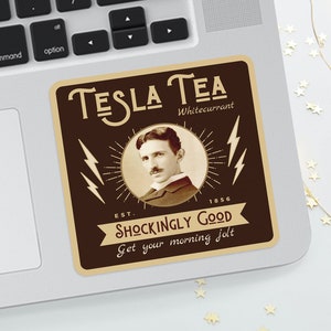 May include: A brown and beige sticker on a laptop featuring the text "TESLA TEA Whitecurrant" with an image of Nikola Tesla. The sticker also includes the text "SHOCKINGLY GOOD" and "Get your morning jolt."