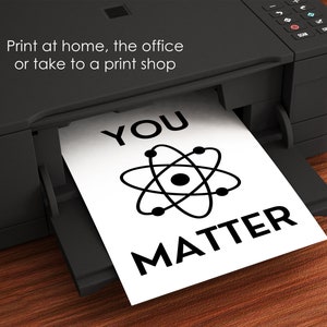 Pu&ograve; includere: Un cartello stampabile in bianco e nero con il testo "You Matter" e un simbolo di atomo. Il cartello viene stampato su una stampante nera.
