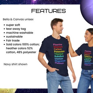 May include: A navy blue t-shirt featuring a vertical list of chemical elements printed in rainbow colors: Fluorine, Uranium, Carbon, Potassium, Titanium, Rubidium, Uranium, Magnesium, and Platinum. The text features a list of product details.