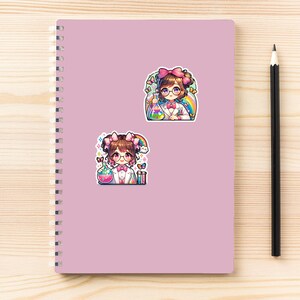 May include: Two colorful stickers featuring a cartoon scientist with brown hair, glasses, and a pink bow. The scientist is wearing a lab coat and holding beakers with colorful liquids. A rainbow and butterflies are also present.