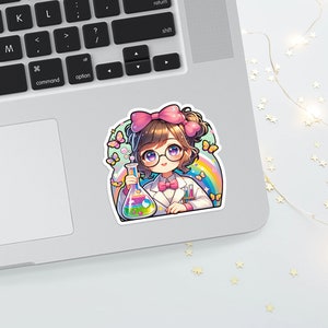 May include: A colorful sticker featuring a cartoon scientist with glasses, a pink bow, and a lab coat, holding a flask with colorful liquids. Butterflies and a rainbow arch around the character. The sticker is placed on a laptop.