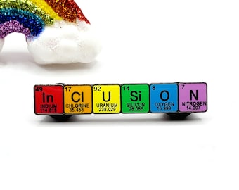 May include: A colorful enamel pin spelling out the word "inclusion" using the chemical symbols for the elements indium, chlorine, uranium, silicon, oxygen, and nitrogen. Each element symbol is displayed on a different colored square.