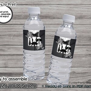 May include: Two clear water bottles with white caps. Each bottle has a black label that says "Best Dad Ever" in white script and block letters, with a bow tie and sunglasses graphic. The text "Ready to Print" and "Digital Download" are also visible.