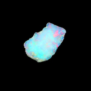 May include: A white ceramic mug with a black handle and the text "But First, Coffee" in a black, handwritten-style font. The mug is on a white surface.