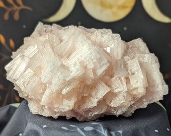 May include: A large cluster of pink Himalayan salt crystals. The crystals are translucent and have a rough, natural texture.