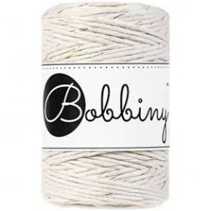 May include: A spool of natural-colored cotton twine with a white label that says "Bobbiny".