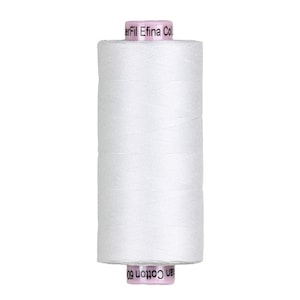 May include: A cylindrical spool of white sewing thread with light pink end caps. The top cap features the text "WonderFil Efina Cotton" and the bottom cap displays the text "Cotton 60". The thread is wound tightly around the central core.