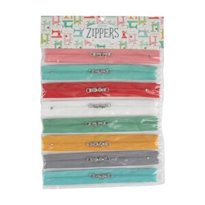 May include: A package of colorful zippers in various shades, including pink, teal, red, white, green, yellow, gray, and turquoise. Each zipper has a silver metal pull and is packaged in a clear plastic bag. The header card reads "Happy Zippers".