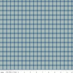May include: A fabric with a blue and light blue plaid pattern. The pattern is a grid of intersecting lines, creating a checkered design. The fabric has a soft, matte appearance. The image includes a ruler along the bottom edge, with measurements in inches.
