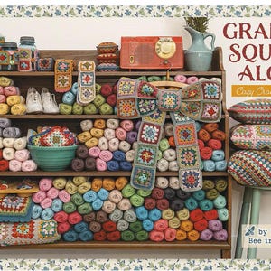 May include: A wooden shelf filled with colorful yarn balls, crochet granny square projects, a teal bowl, a vintage red radio, and a pitcher. Text reads Granny Square Along Cozy Crochet Series by Lori Holt of Bee in my Bonnet. Three pillows sit on a stool.
