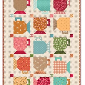 May include: A rectangular quilt featuring a repeating pattern of twelve stylized tea cups arranged in a grid. Each cup displays a unique color and fabric print, including floral, polka dot, and gingham patterns, set against a cream polka dot background.