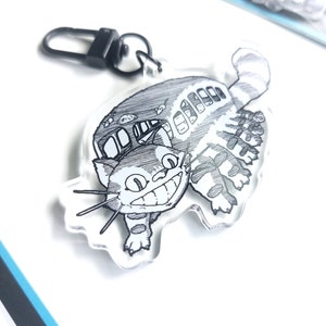 Chaveiro de acrílico com pingente de gato voador - inspirado em anime