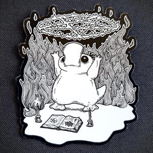 May include: A black and white illustration of a platypus performing a ritual. The platypus is standing on a pentagram with two candles on either side. The platypus is holding its arms up in the air, and a circle of fire is above its head. The platypus is wearing a crown.