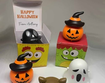 May include: A collection of Halloween-themed figurines, including a jack-o'-lantern, a bat, and a ghost. Some figurines are in decorative boxes with the text "HAPPY HALLOWEEN From Anthony."