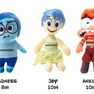 May include: Three plush toys from the movie Inside Out: Sadness, Joy, and Anxiety. Sadness is blue and wearing glasses, Joy is yellow and wearing a dress, and Anxiety is orange and wearing a striped shirt and pants. Each toy is 8 or 10 inches tall.