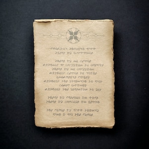 May include: Aged parchment paper with an ornate design at the top and rows of stylized text. The paper has a rough, textured surface and a warm, yellowish-brown color. The text appears to be in a unique, stylized font, adding to the vintage aesthetic.