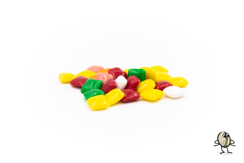 May include: A pile of colorful chewing gum squares in red, yellow, green, white, and pink.