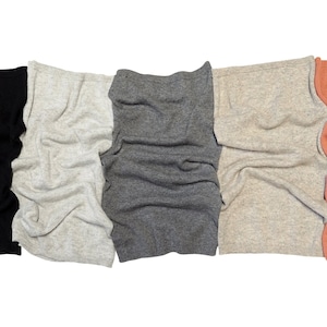 May include: Five different colored knitted scarves, black, white, gray, beige, and coral.