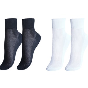 May include: Two pairs of ankle socks, one pair black and one pair white.