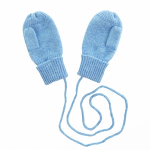 May include: A pair of light blue knitted mittens with a matching string. The mittens have a ribbed cuff and are connected by a light blue cord. The mittens are designed to keep hands warm in cold weather.