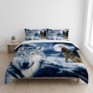 May include: A duvet cover and pillowcases with a wolf design. The bedding set features images of wolves howling at the moon against a dark blue night sky. The set includes a large wolf face and a full moon.
