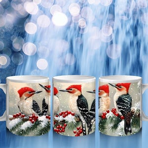 May include: Three white ceramic mugs with a winter scene featuring red-headed woodpeckers perched on a snowy branch with red berries.