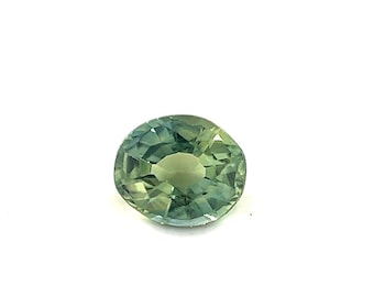 May include: A green oval-shaped gemstone with a faceted cut.