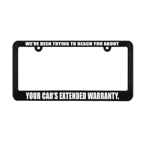 May include: Black license plate frame with white text that reads "WE'VE BEEN TRYING TO REACH YOU ABOUT YOUR CAR'S EXTENDED WARRANTY."