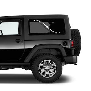 May include: A black Jeep SUV with a white curved decal on the rear window. The decal has a dot at each end and one in the middle. The vehicle has black tires and a spare tire mounted on the back.