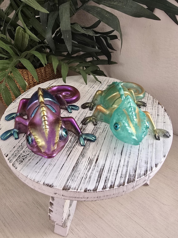 Handpoured resin shifts between metallic purple and teal depending on the angle — a tiny iridescent chameleon that's basically mood lighting without the electricity.