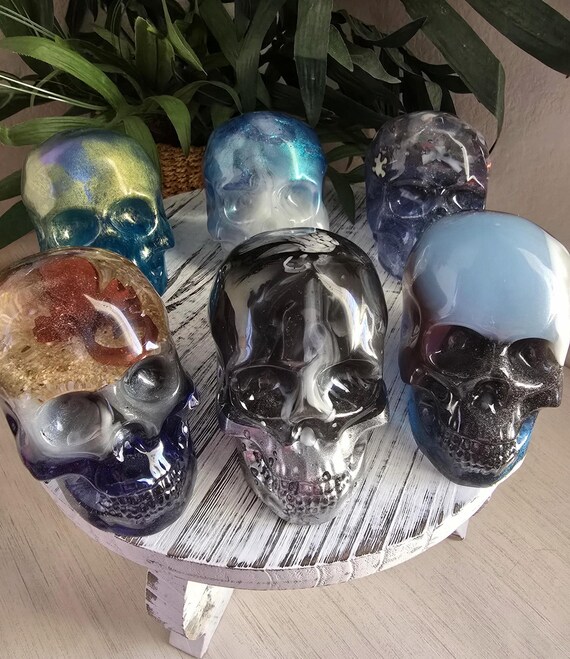 Iridescent chameleon-finish resin skull that shifts color in the light — handmade oddity that earns a double-take on any shelf.