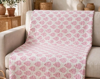 May include: A rectangular cotton quilt featuring a repeating pattern of pink leaf motifs printed on a white background. The fabric has a visible quilted texture with fine stitching lines throughout, and the edges are finished with a simple pink border.