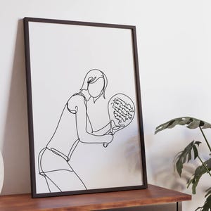 May include: A black and white line drawing of a person playing paddle tennis. The person is holding a paddle in their right hand and is in a crouched position.