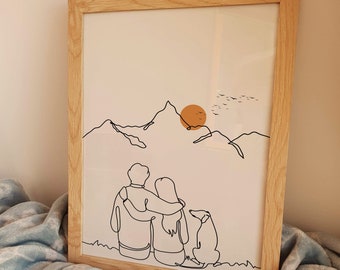 May include: A framed line art print of a couple holding each other with a dog sitting in front of them. The couple and dog are facing away from the viewer. The background is a mountain range with a setting sun.