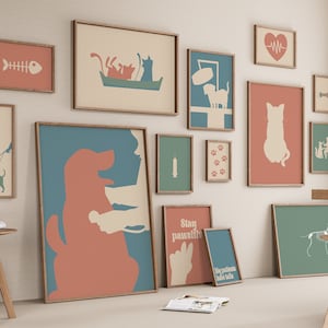 May include: A wall gallery featuring framed prints with various pet-themed illustrations. The prints feature silhouettes of cats and dogs, bones, paw prints, a heart with a heartbeat line, and text that says "Stay pawsitive".
