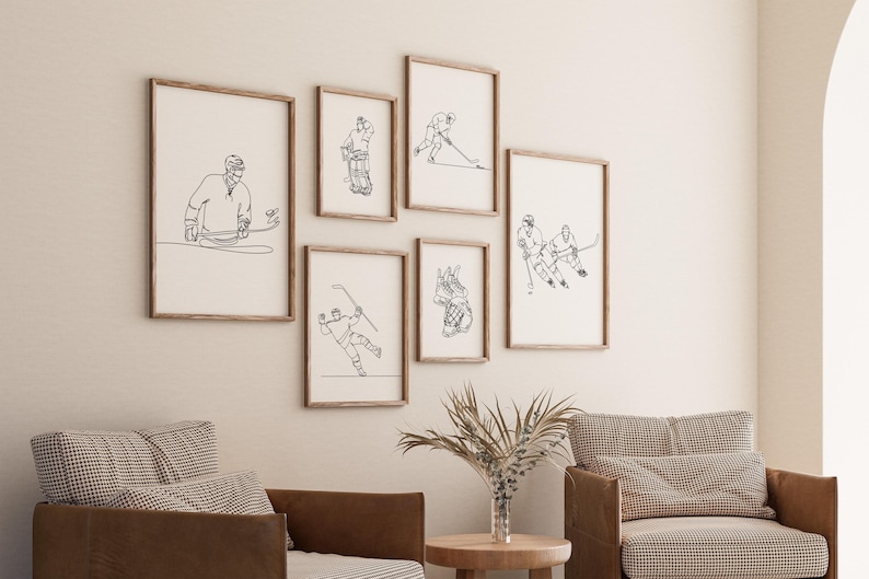 May include: A set of six black and white line art prints featuring hockey players in various poses. The prints are framed in natural wood frames and are displayed on a white wall.