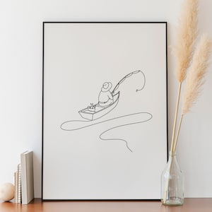 Può includere: Stampa artistica con cornice nera raffigurante un pescatore su una barca, disegnata con una linea continua. L'opera minimalista mostra una persona con canna da pesca e barca. La stampa è esposta su un mobile in legno.